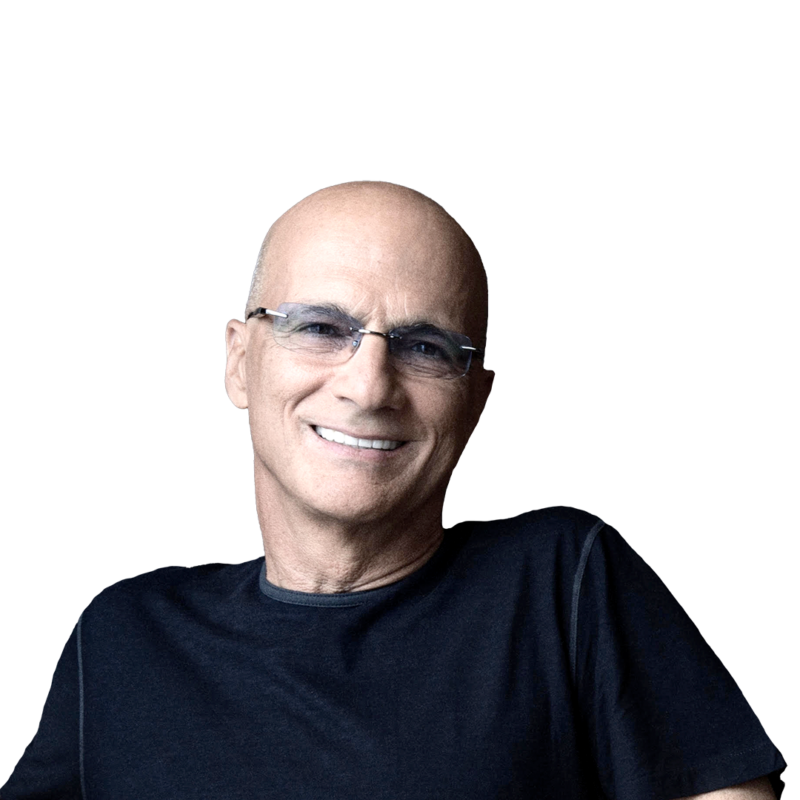 Jimmy Iovine wearing a dark T-shirt and glasses while smiling.